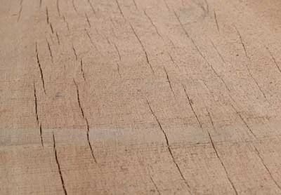 UV-bleached weathered Apitong showing surface graying after years without finish